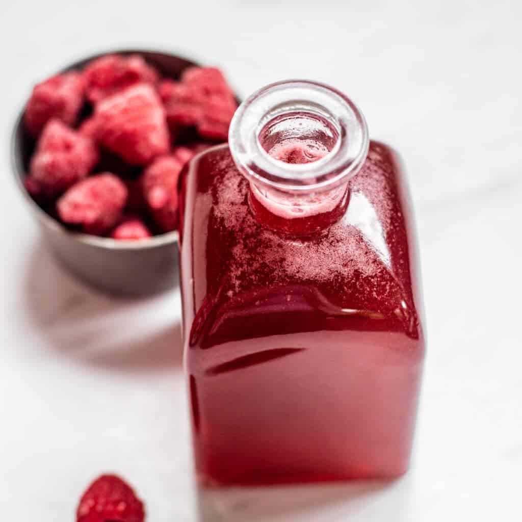 red syrup with raspberries.