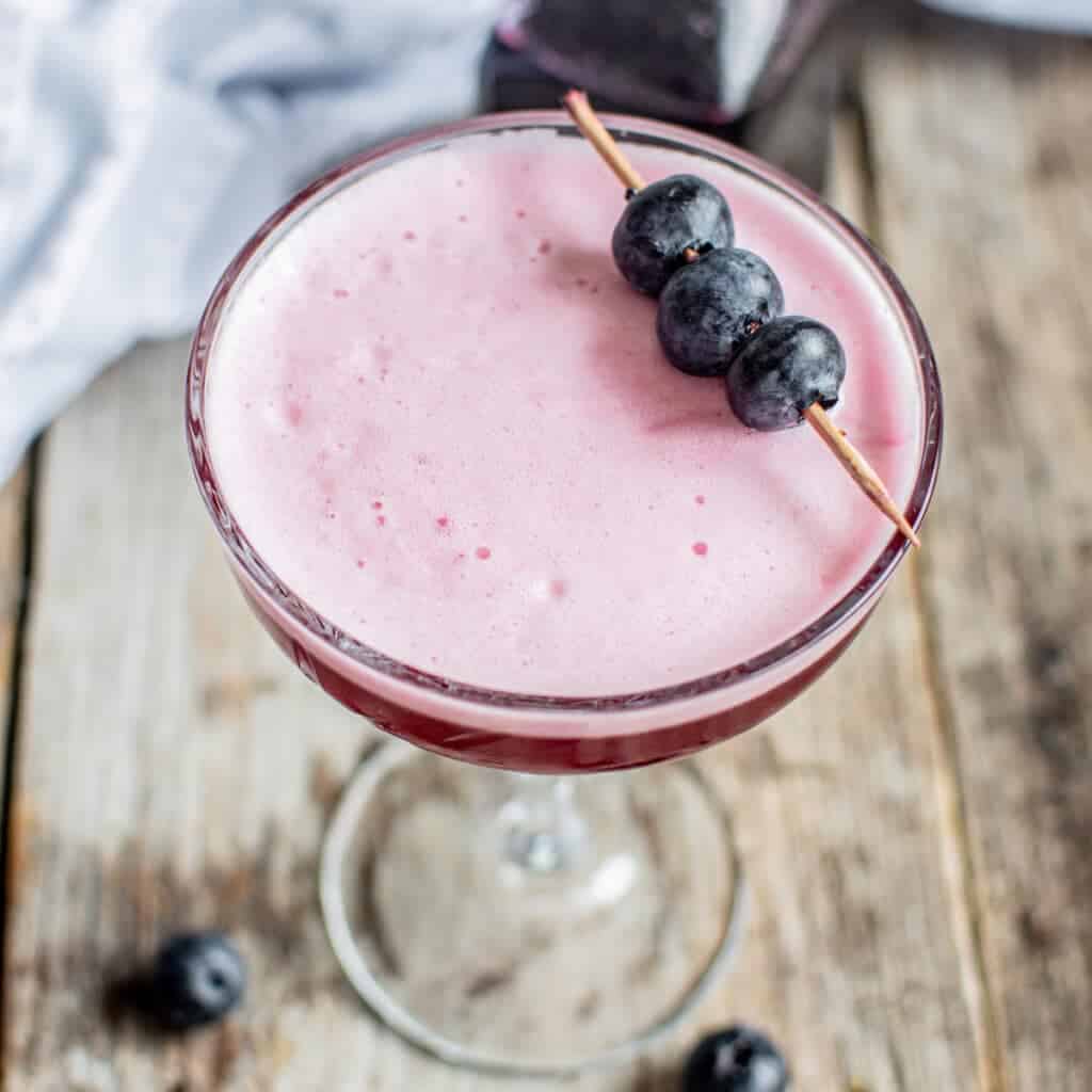 close up of blueberry sour cocktail.