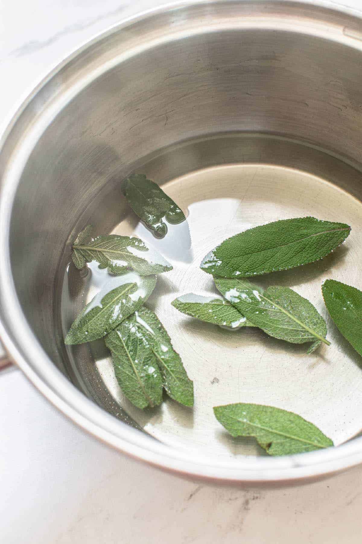 sage leaves in saucepan.