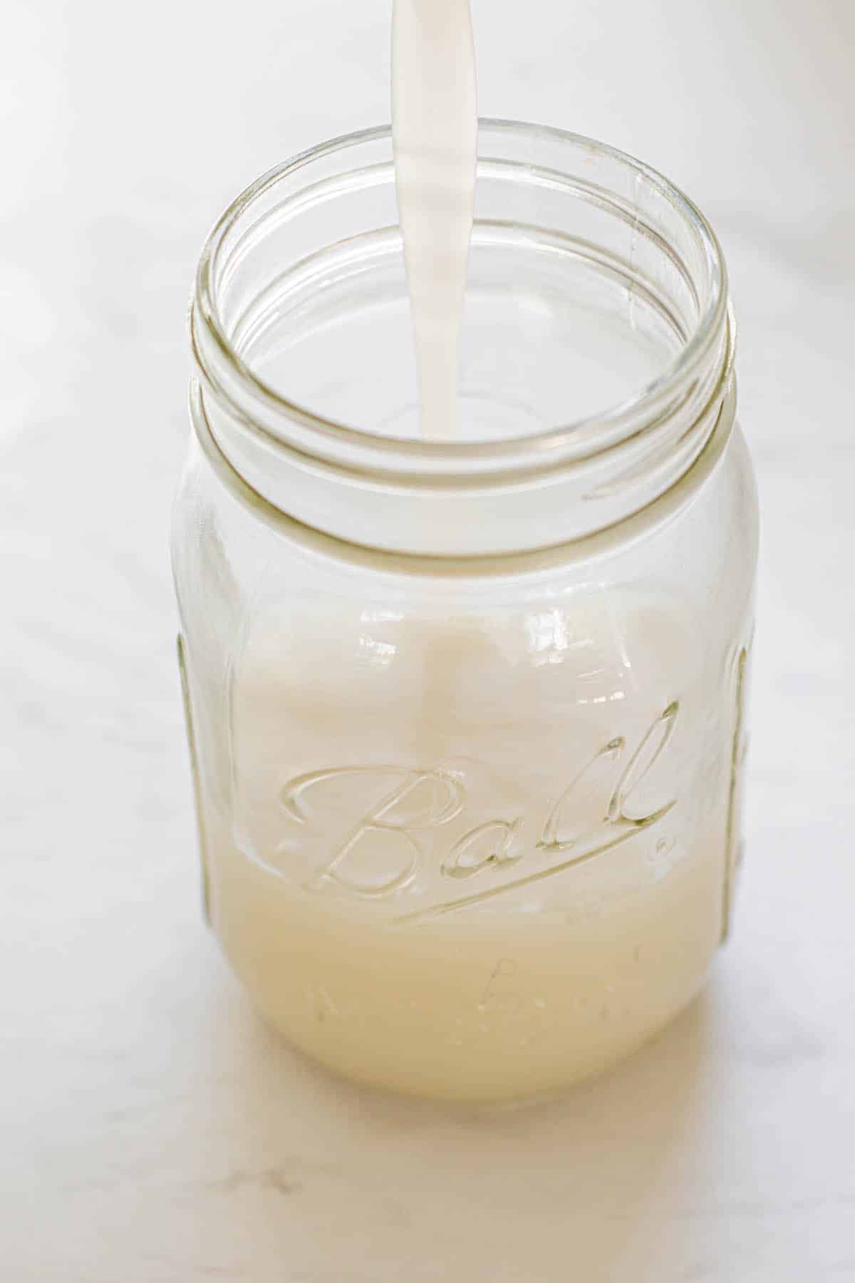 cream of coconut in ⅓rd of a glass mason jar.