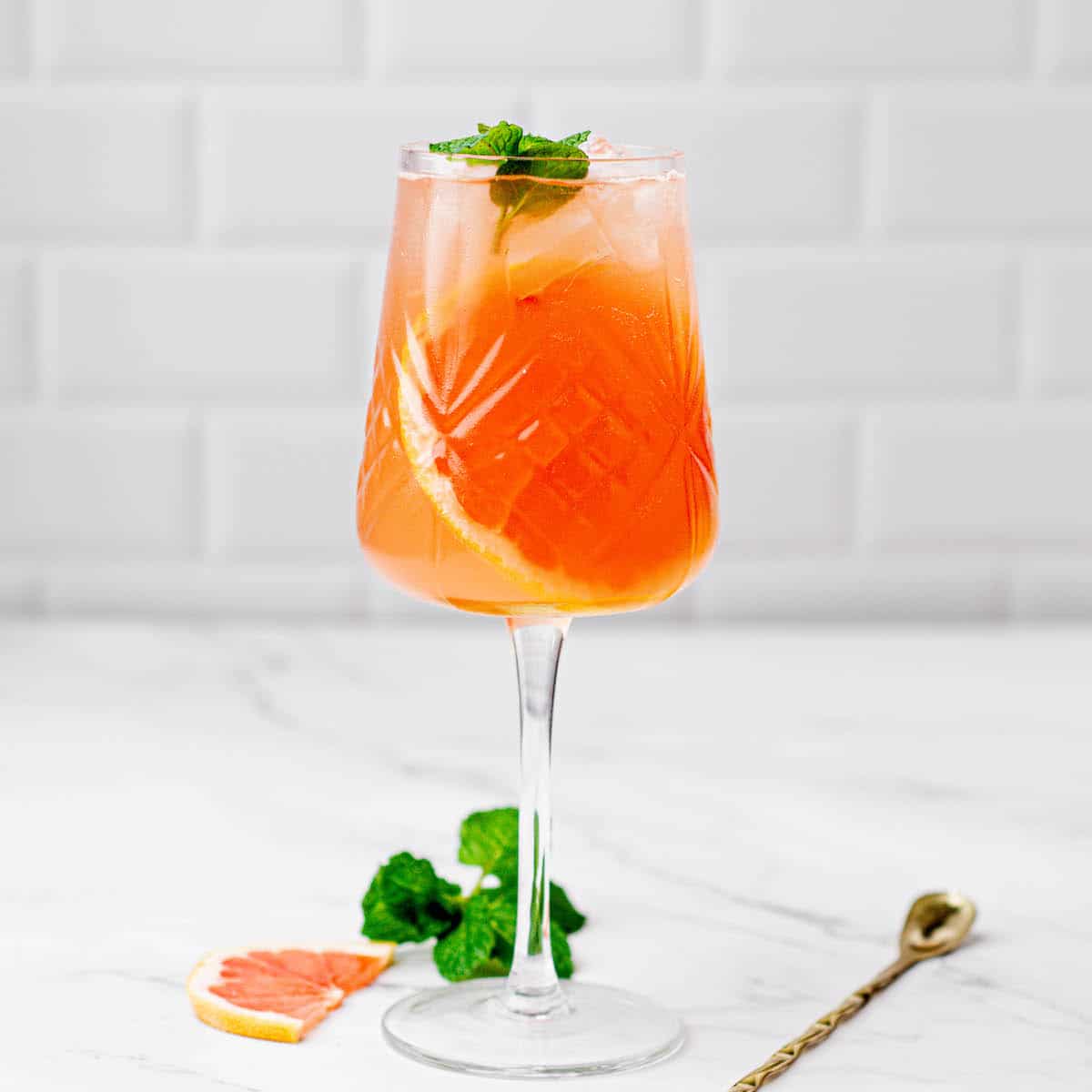 orange cocktail with green mint.