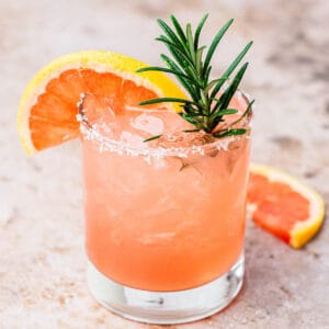 salty dog cocktail with rosemeary sprig.