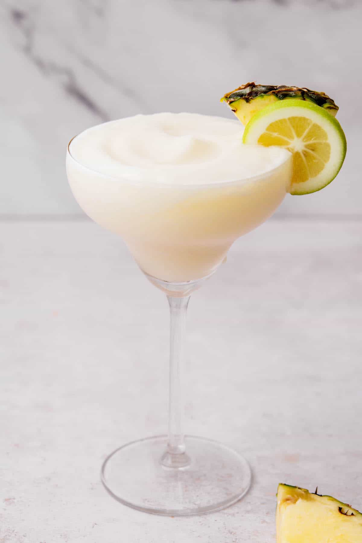 side view of pina colada in a margarita glass.