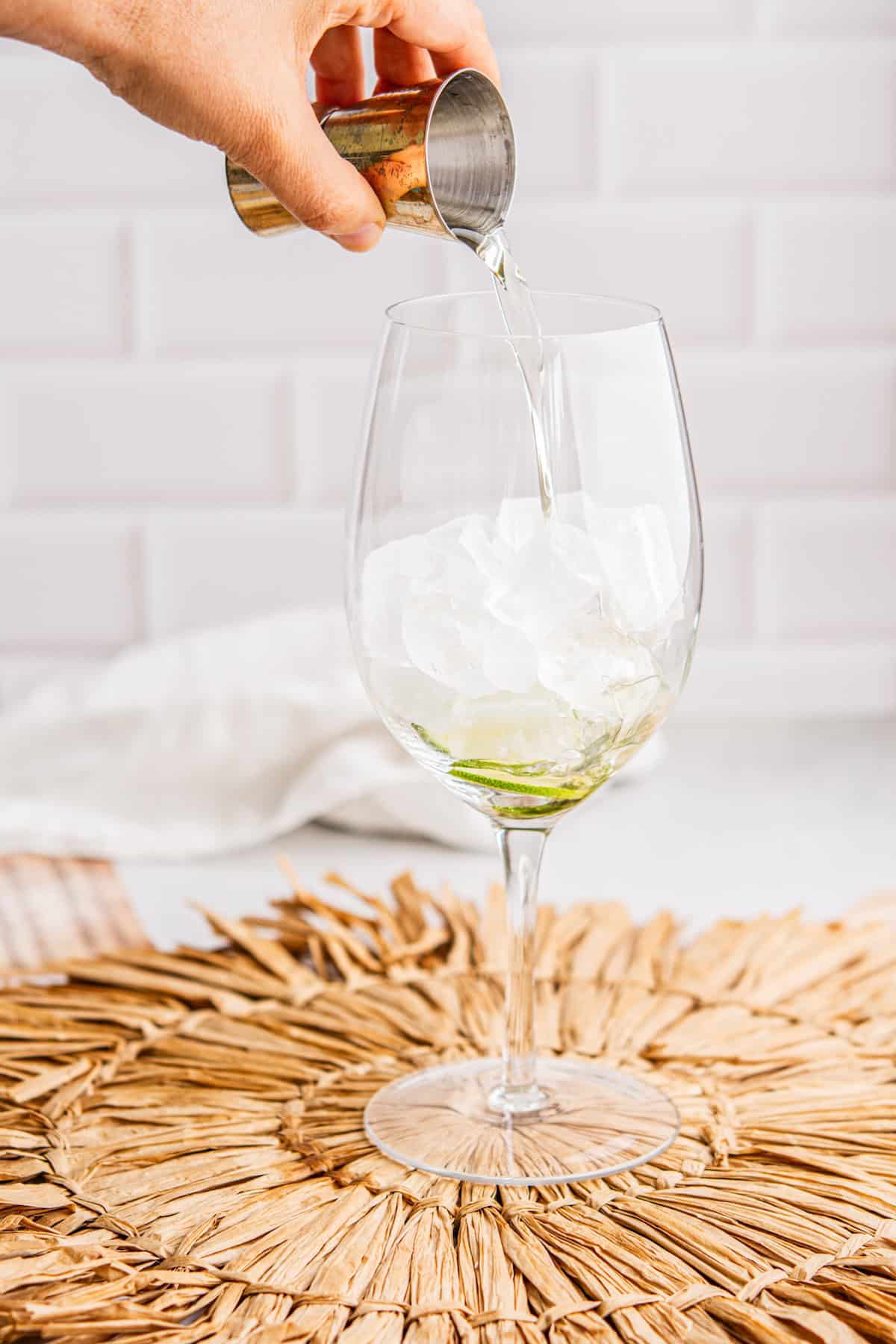 elderflower liqueur poured into glass.